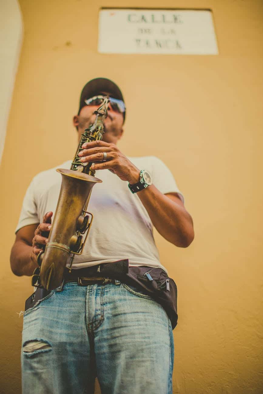 shallow focus photo of man playing saxophone